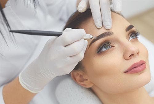 Scalp micropigmentation being applied to replicate the look of hair follicles