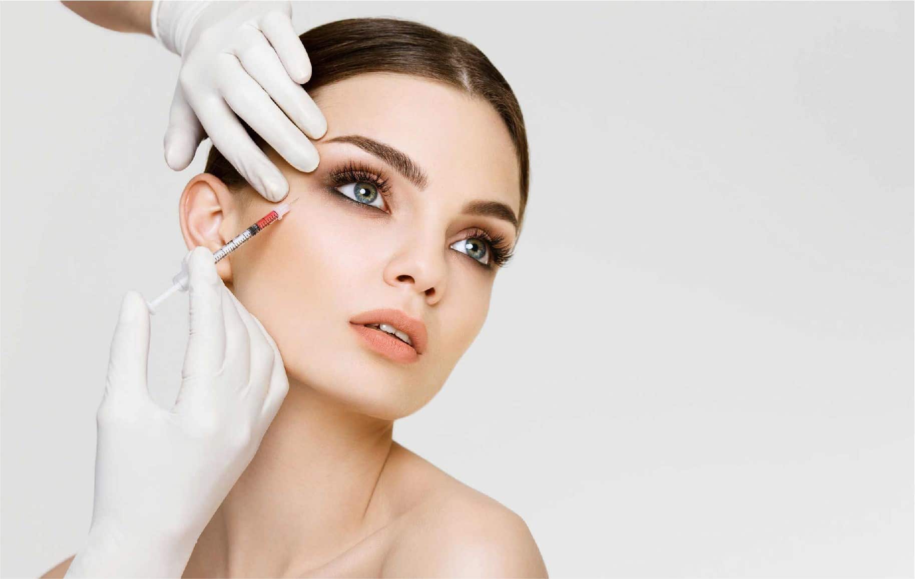 A facial micro-injection session being administered by a doctor at The Aesthetic Edge