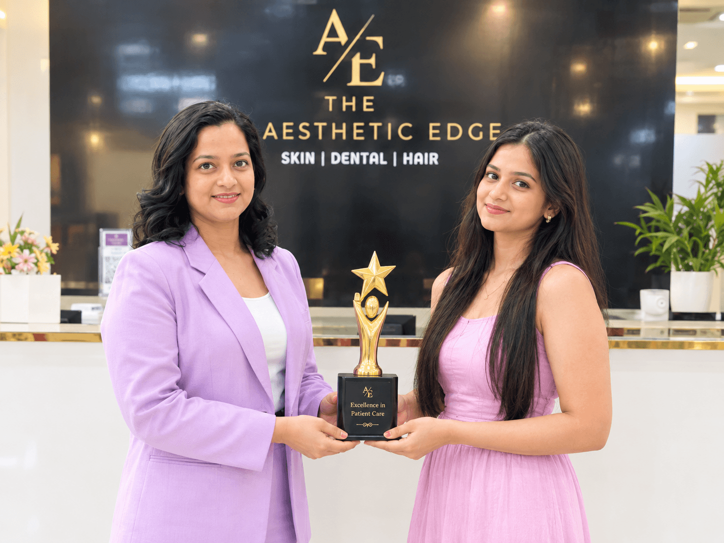 A member of The Aesthetic Edge team being presented with the clinic's Excellence in Patient Care award at reception