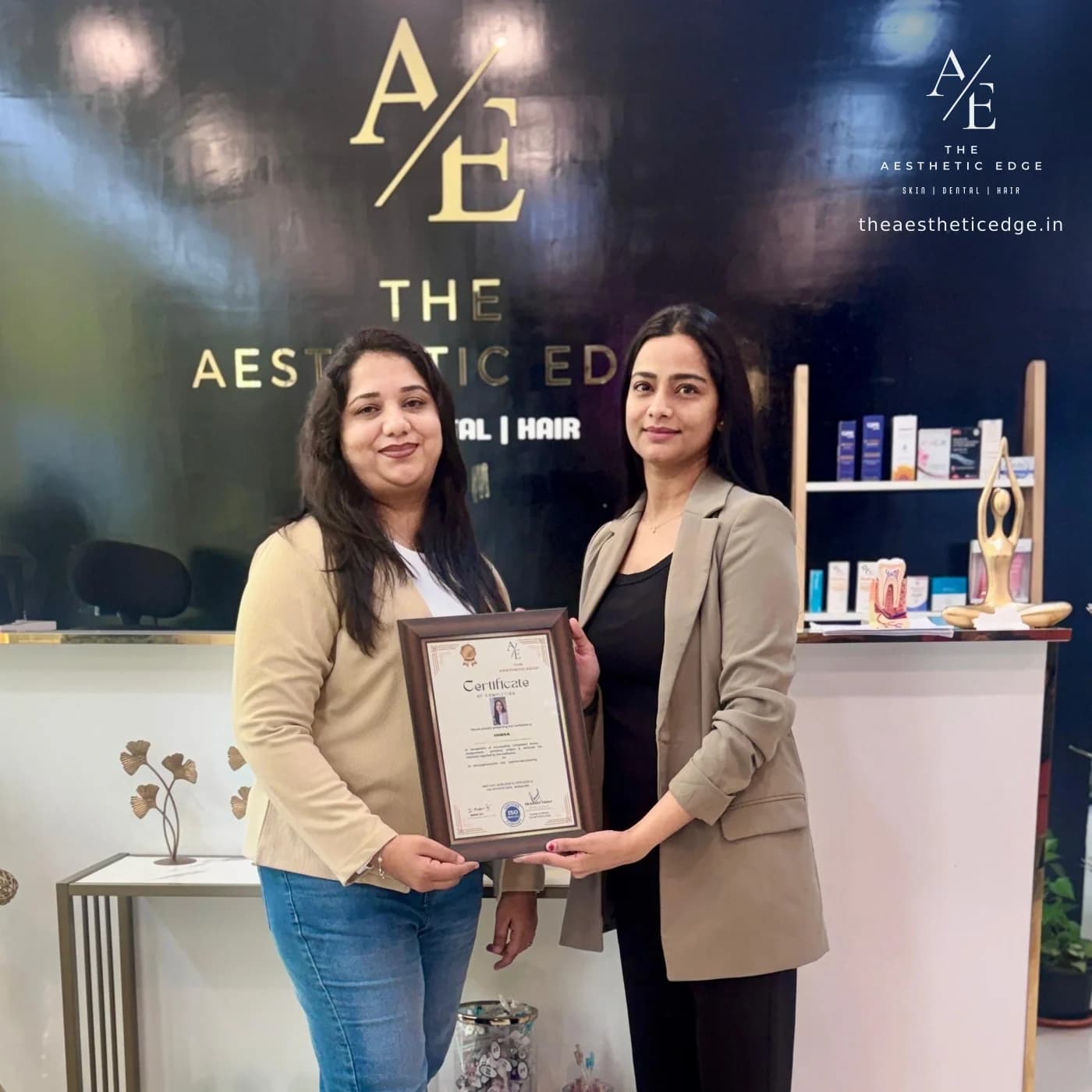 A framed Aesthetic Edge certificate of completion being handed over at the clinic reception, in front of the branded wall