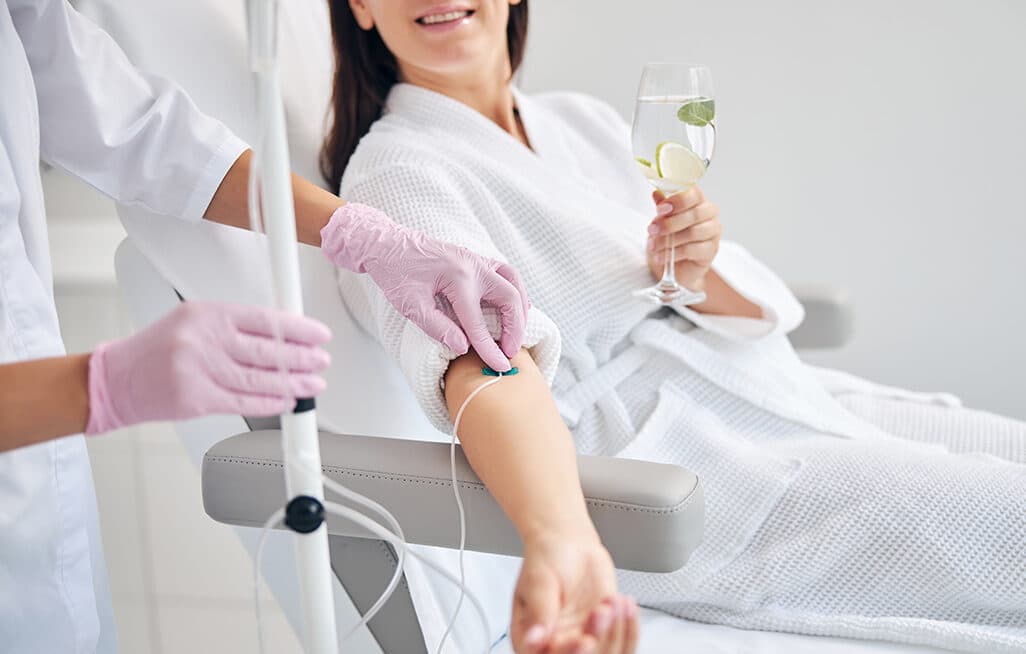 A glow drip IV infusion being administered by a doctor at The Aesthetic Edge