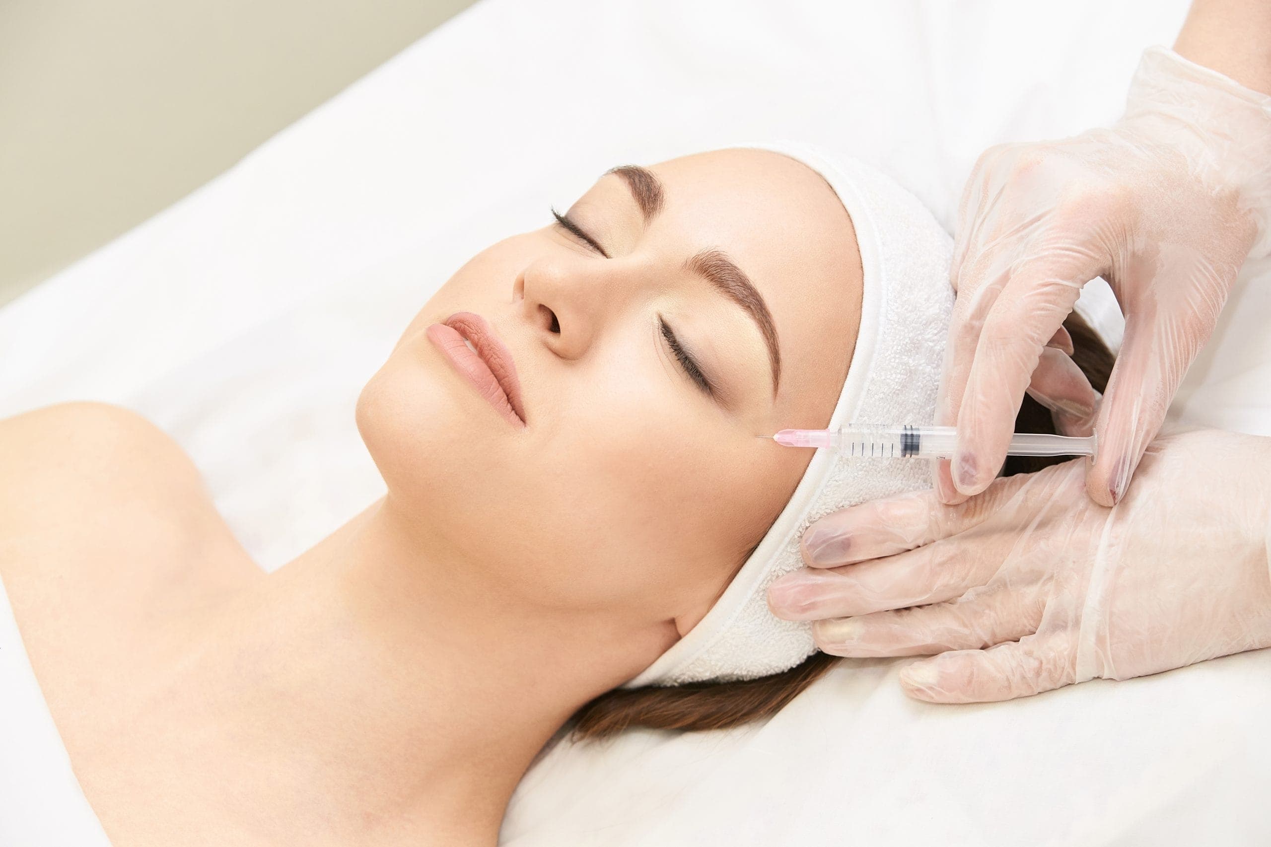 Doctor marking treatment areas before a wrinkle relaxer injection at The Aesthetic Edge